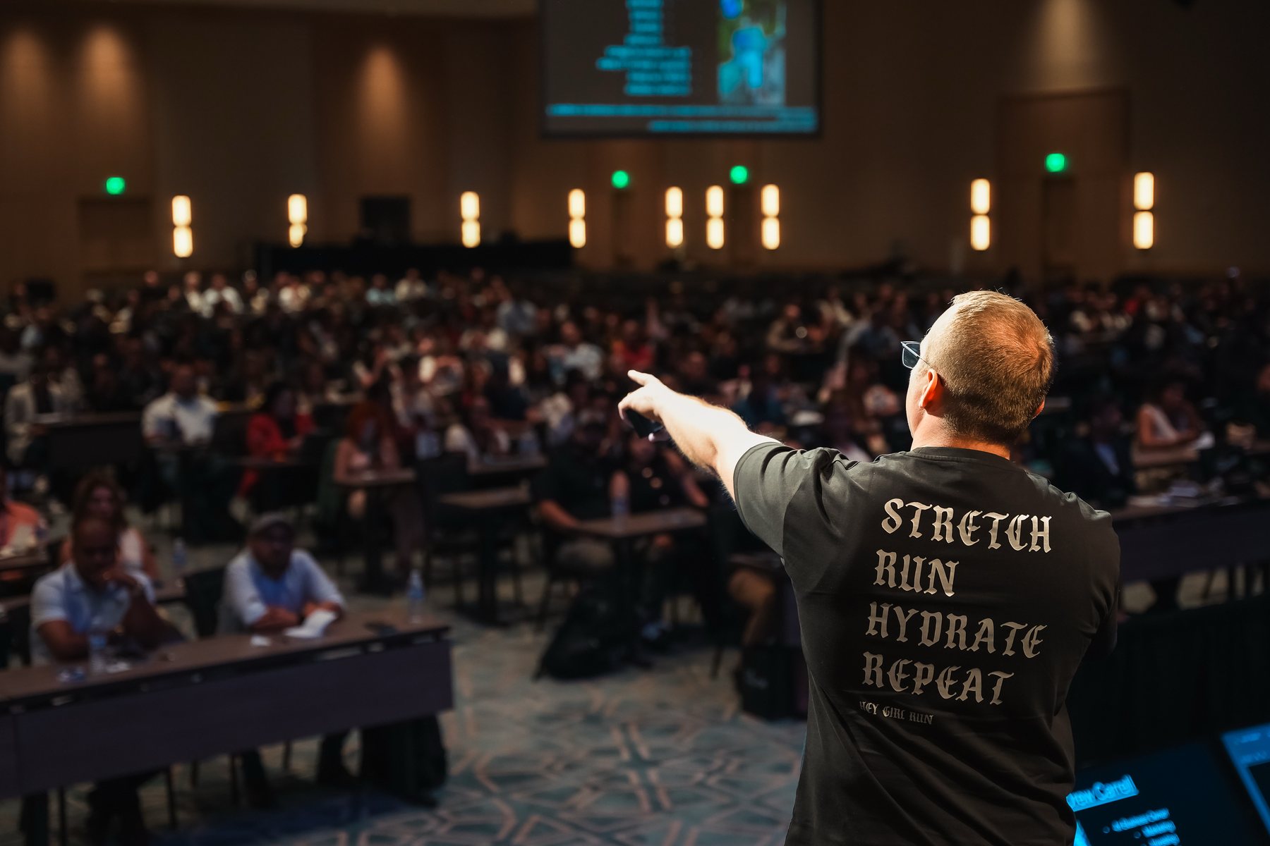 Drew Carrell speaking to a conference crowd